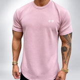 The Sweat District Performance Tee in Coral (pale dusty pink) — AI development garment visualization
