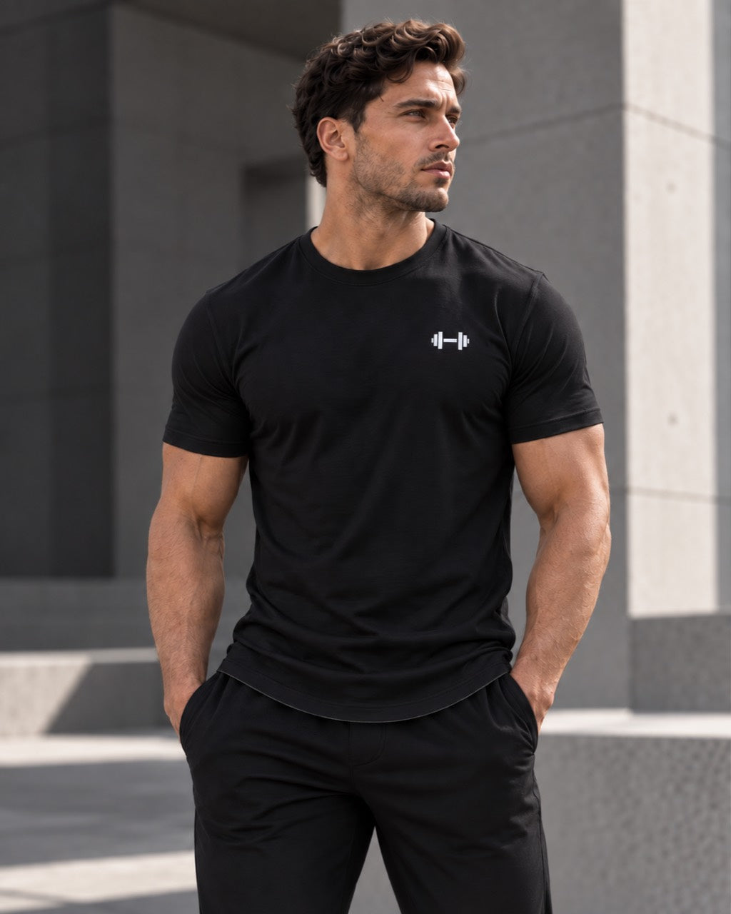 Black Form Muscle Tee, closer three-quarter fit view with the curved hem visible.