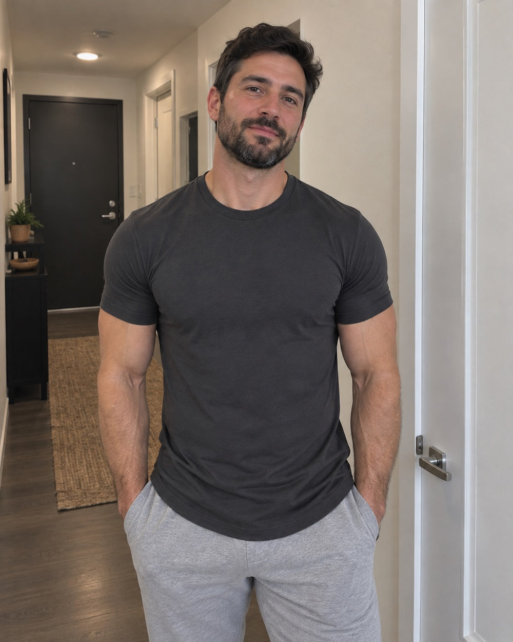 Charcoal Sculpt Tee in a hallway. The Sweat District styling image.
