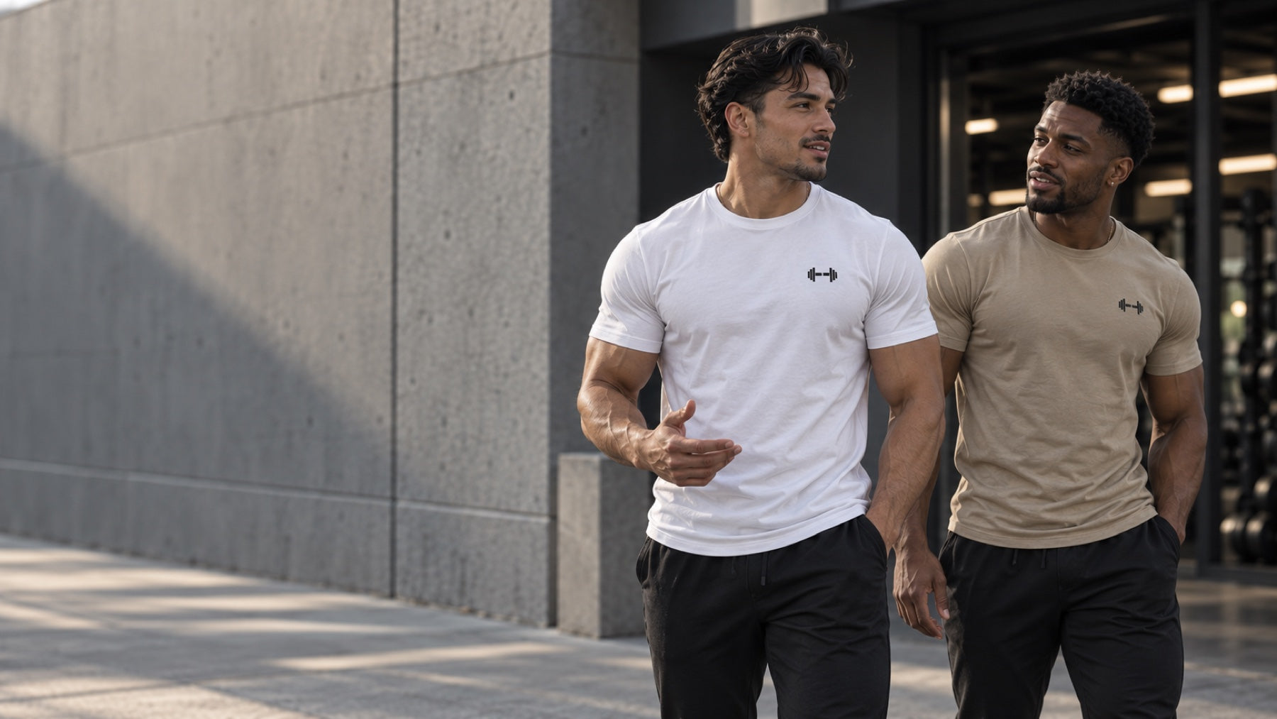 Two men wearing white and stone Form Muscle Tees outside the gym
